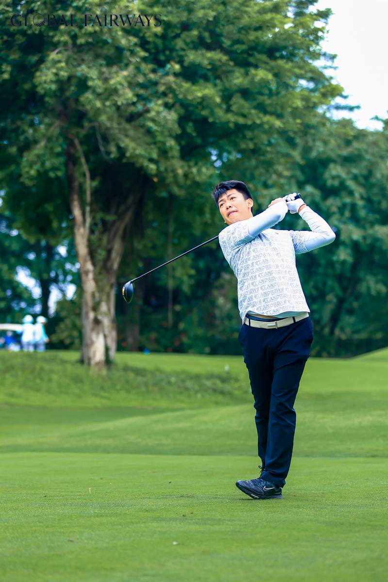 A golfer following through on a shot